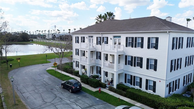 770 Siena Palm Dr Unit 201, Celebration, FL 34747 - view of building exterior featuring driveway and a water view
