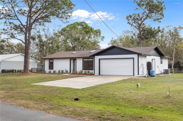 ranch-style house with concrete driveway, an attached garage, a front yard, central AC, and fence