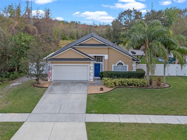 ranch-style house featuring a front lawn and a garage