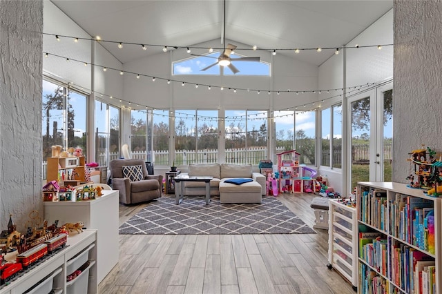 sunroom featuring track lighting, vaulted ceiling, and ceiling fan