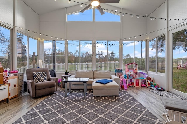 sunroom / solarium featuring ceiling fan, vaulted ceiling, plenty of natural light, and track lighting