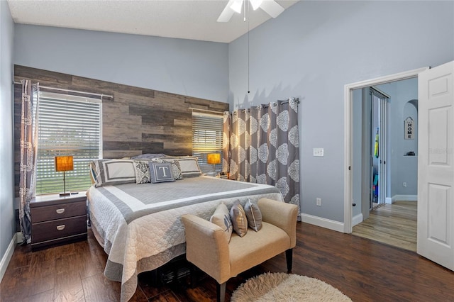 bedroom with multiple windows, high vaulted ceiling, ceiling fan, and dark hardwood / wood-style floors