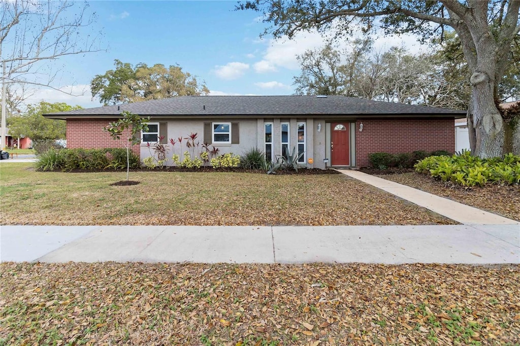 5359 Lanyard Ct, Winter Park, FL 32792 - ranch-style home with brick siding and a front lawn