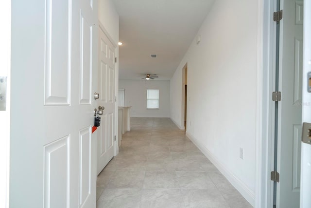 corridor featuring light tile patterned floors