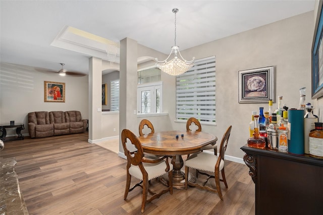 dining space with hardwood / wood-style floors and a chandelier