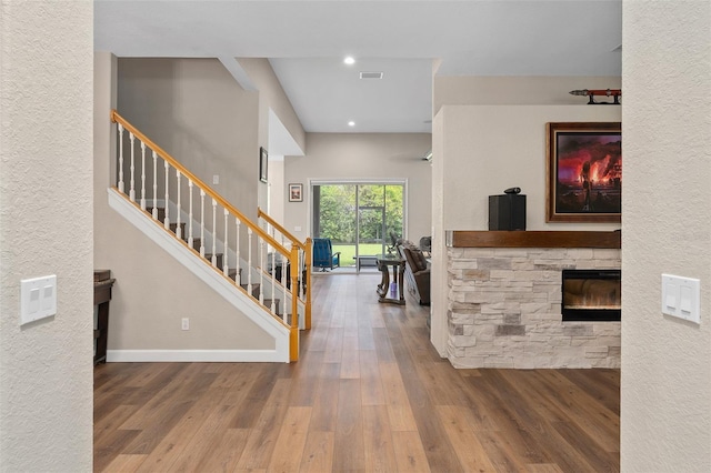 foyer entrance with hardwood / wood-style flooring and a fireplace