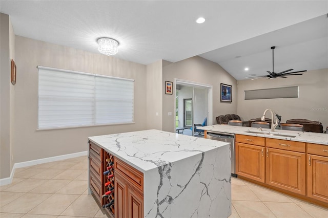 kitchen featuring a kitchen island, sink, stainless steel dishwasher, light tile patterned floors, and light stone counters