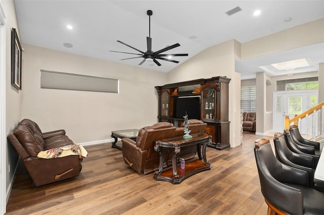 living room featuring lofted ceiling, hardwood / wood-style flooring, and ceiling fan