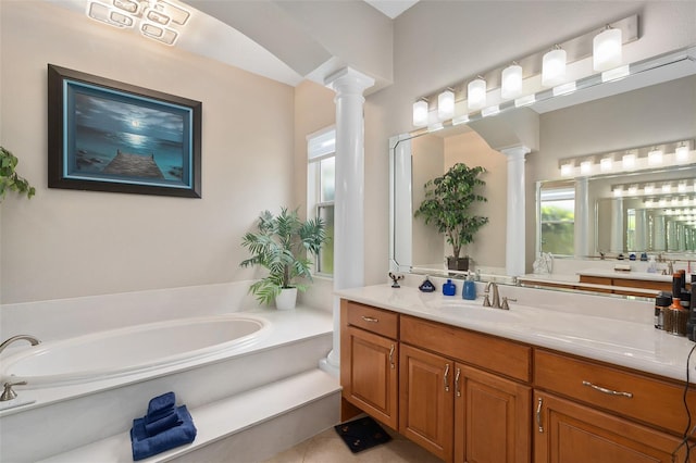 bathroom featuring vanity, a bathing tub, and decorative columns