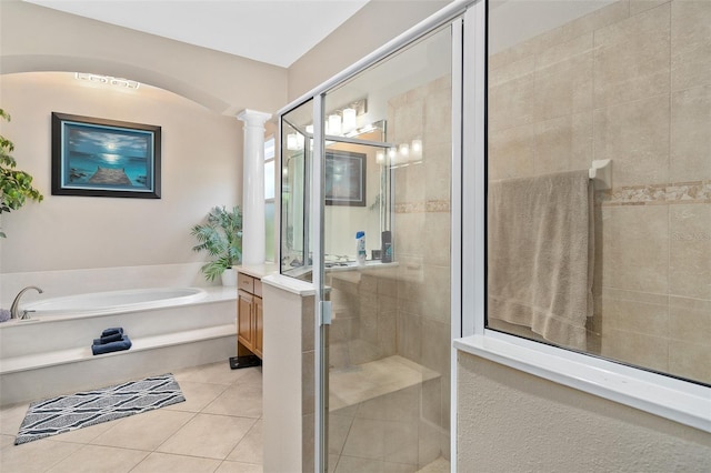 bathroom featuring vanity, tile patterned floors, plus walk in shower, and ornate columns