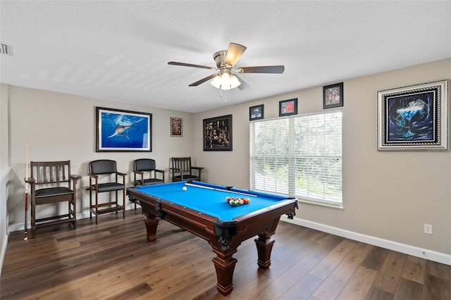 recreation room featuring dark wood-type flooring, pool table, ceiling fan, and a textured ceiling