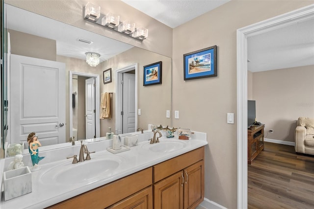 bathroom with wood-type flooring and vanity