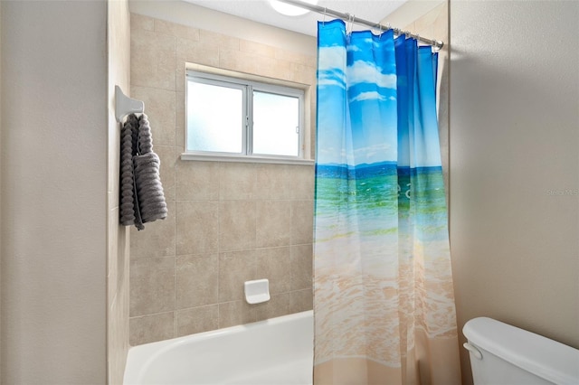 bathroom featuring shower / bathtub combination with curtain and toilet