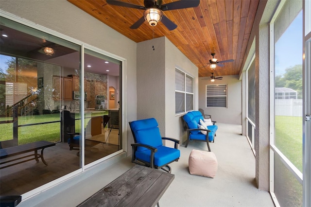 sunroom / solarium featuring ceiling fan and wooden ceiling