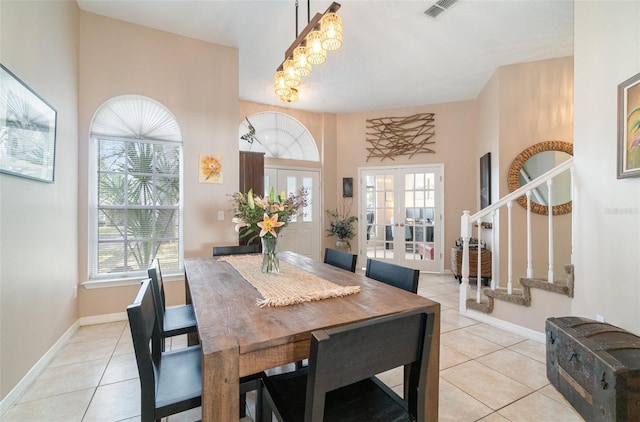 dining area with french doors, plenty of natural light, and light tile patterned floors