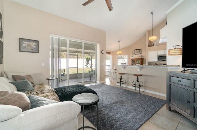 tiled living room with high vaulted ceiling and ceiling fan