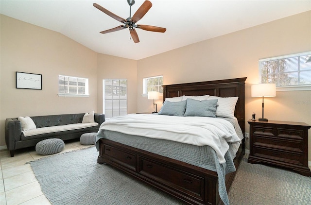 bedroom featuring multiple windows, vaulted ceiling, ceiling fan, and light tile patterned floors
