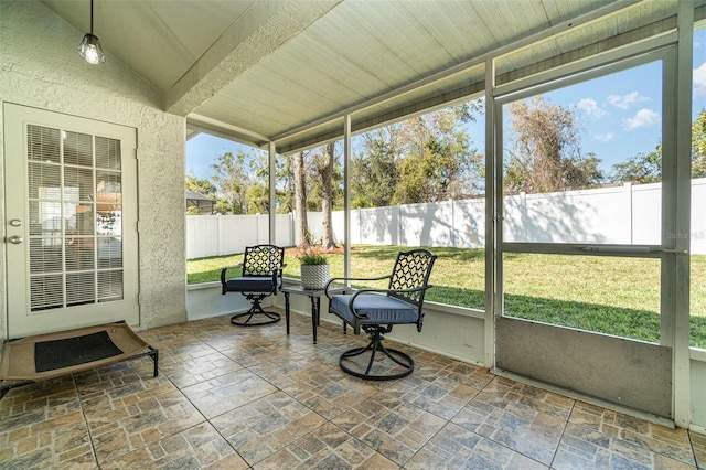 sunroom featuring vaulted ceiling