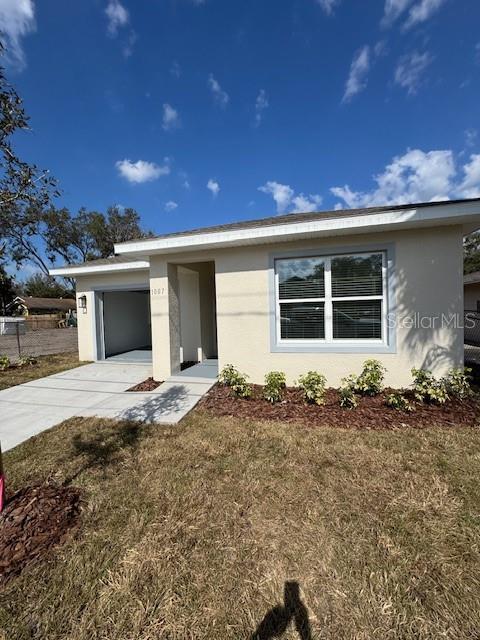 view of front of home featuring a garage and a front lawn