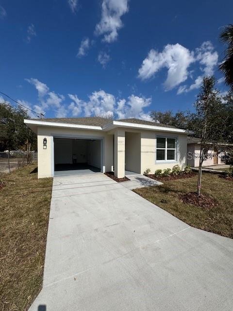 single story home with a garage and a front yard