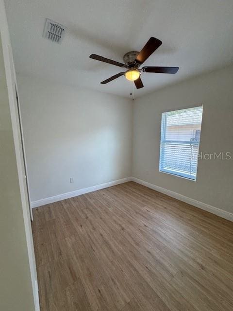 empty room featuring ceiling fan and light wood-type flooring