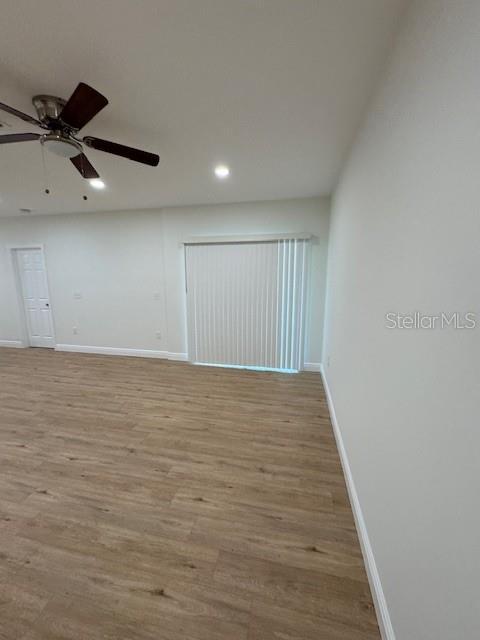 unfurnished room with ceiling fan and light hardwood / wood-style flooring