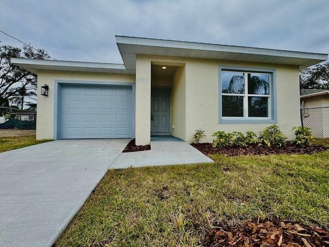 view of front of home featuring a garage and a front lawn