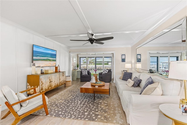 living area featuring ceiling fan, wood finished floors, and ornamental molding