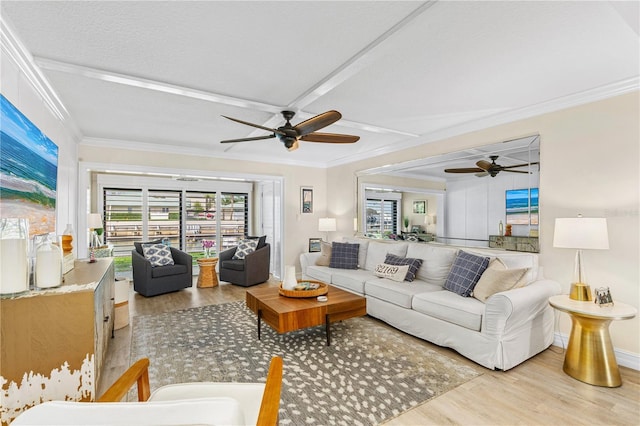 living room featuring baseboards, light wood-style floors, ceiling fan, and ornamental molding