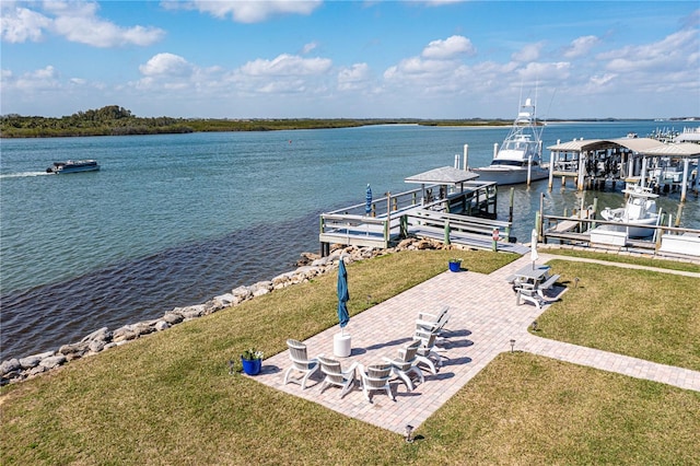 view of dock with boat lift, a water view, a lawn, and a patio