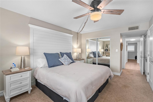 bedroom featuring visible vents, a ceiling fan, a closet, carpet, and baseboards