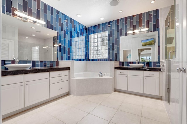 bathroom with a shower stall, tile walls, and a sink