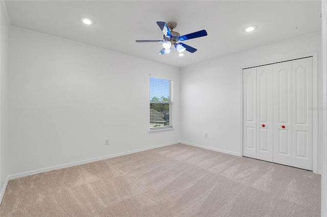 unfurnished bedroom featuring baseboards, recessed lighting, carpet flooring, and crown molding