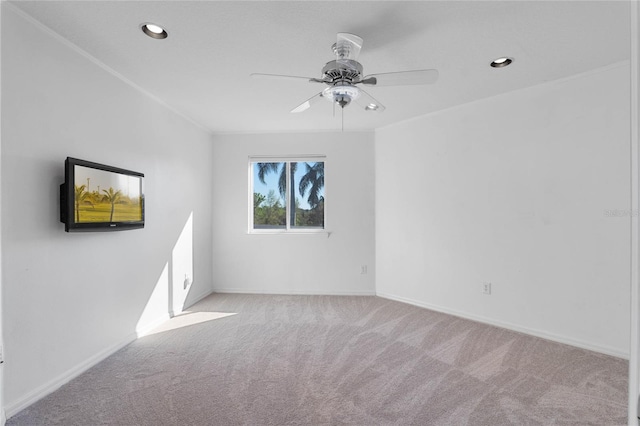 spare room with ceiling fan, recessed lighting, carpet flooring, baseboards, and crown molding