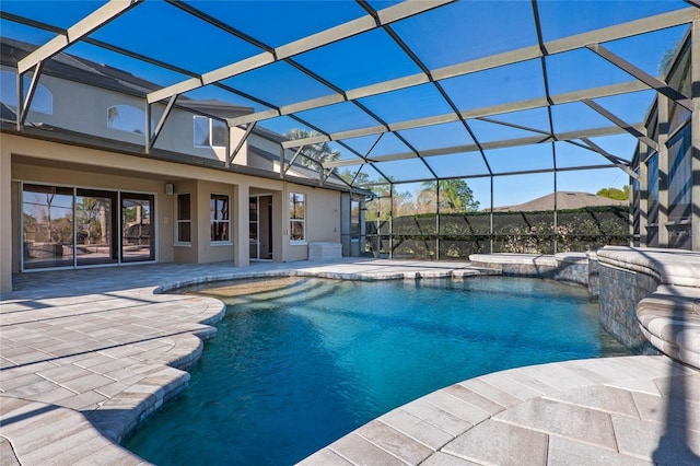 pool with a patio and glass enclosure