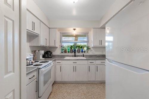 kitchen with white appliances and sink