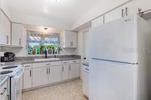 kitchen featuring sink and white appliances