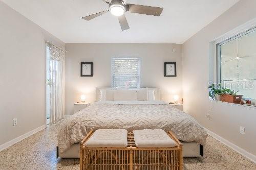 bedroom featuring multiple windows and ceiling fan