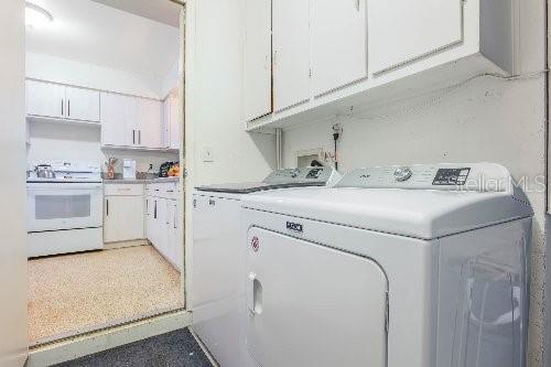 laundry room featuring cabinets and separate washer and dryer