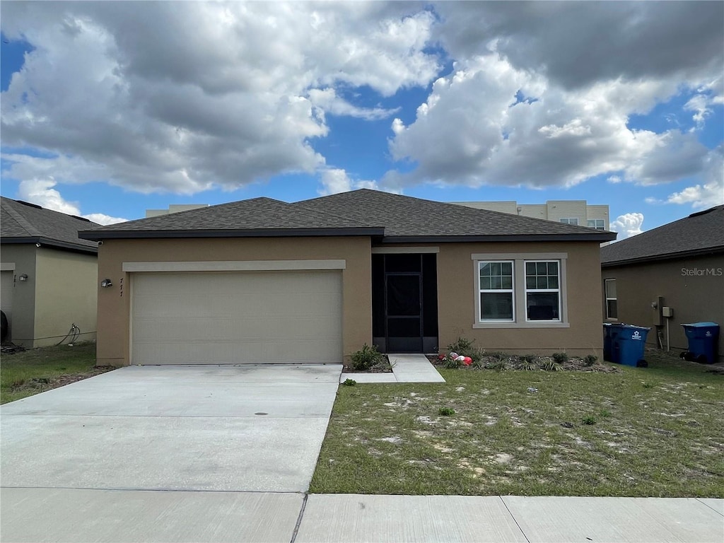 view of front facade with a garage and a front yard