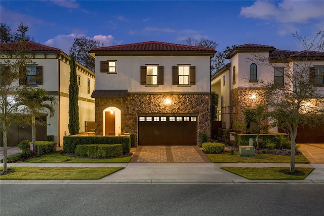 mediterranean / spanish-style home featuring a garage