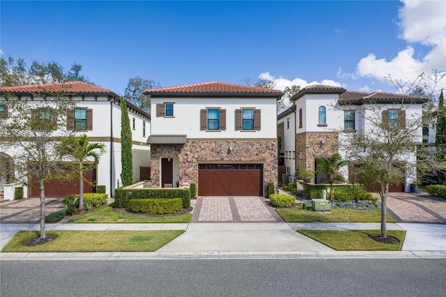 mediterranean / spanish-style house with a garage