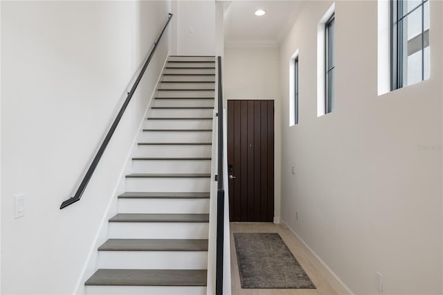 stairs featuring crown molding