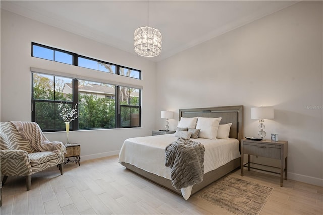 bedroom featuring a notable chandelier and light hardwood / wood-style floors