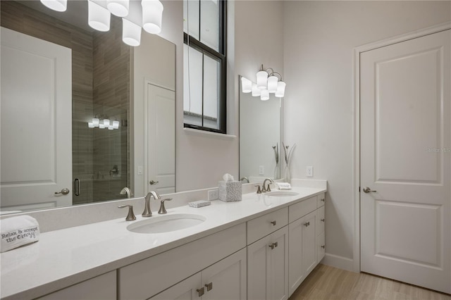 bathroom featuring vanity, an enclosed shower, and wood-type flooring