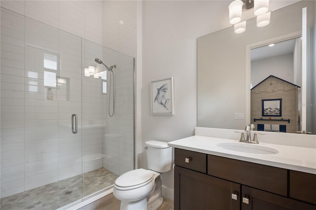 bathroom with vanity, walk in shower, a chandelier, and toilet