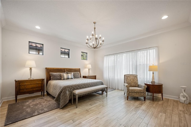 bedroom featuring crown molding, a notable chandelier, and light hardwood / wood-style floors