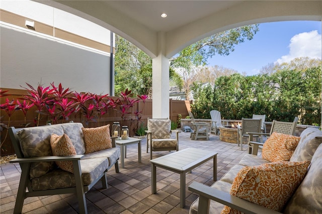 view of patio / terrace with an outdoor living space with a fire pit