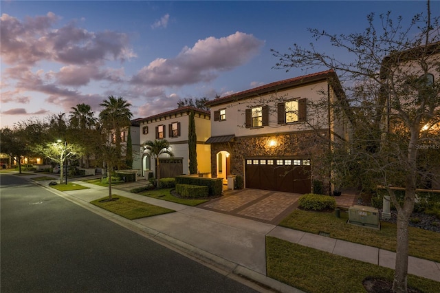 mediterranean / spanish house with a garage