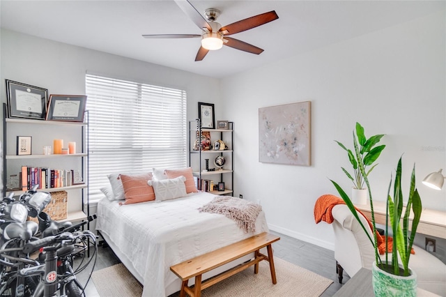 bedroom with wood-type flooring and ceiling fan